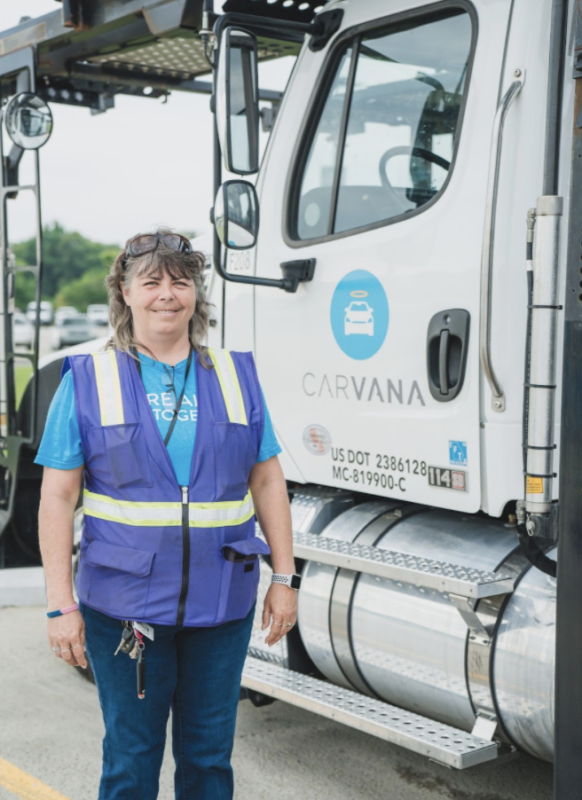 female truck driver in front of truck