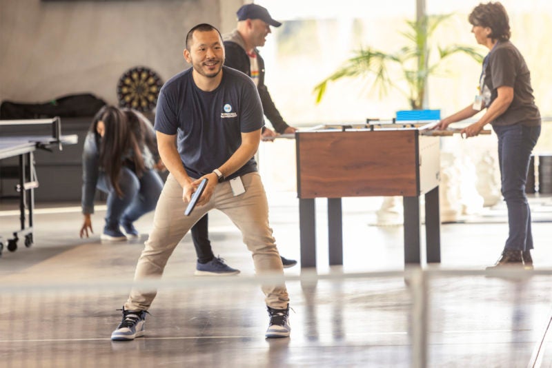 employees playing pickleball in office