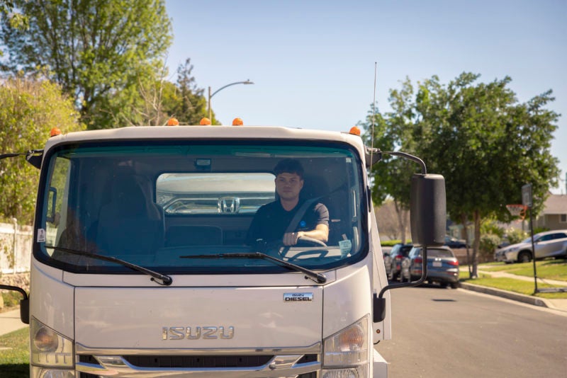 carvana driver driving delivery truck