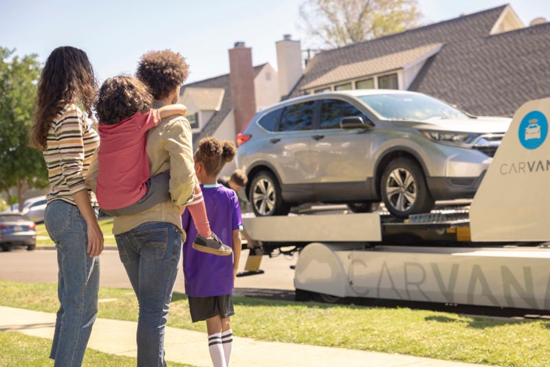 family watching their car be delivered