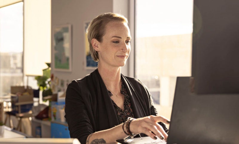 female engineer writing code on laptop