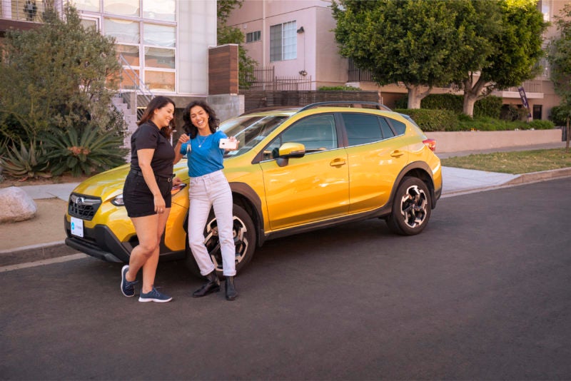 customers in front of car purchased via app